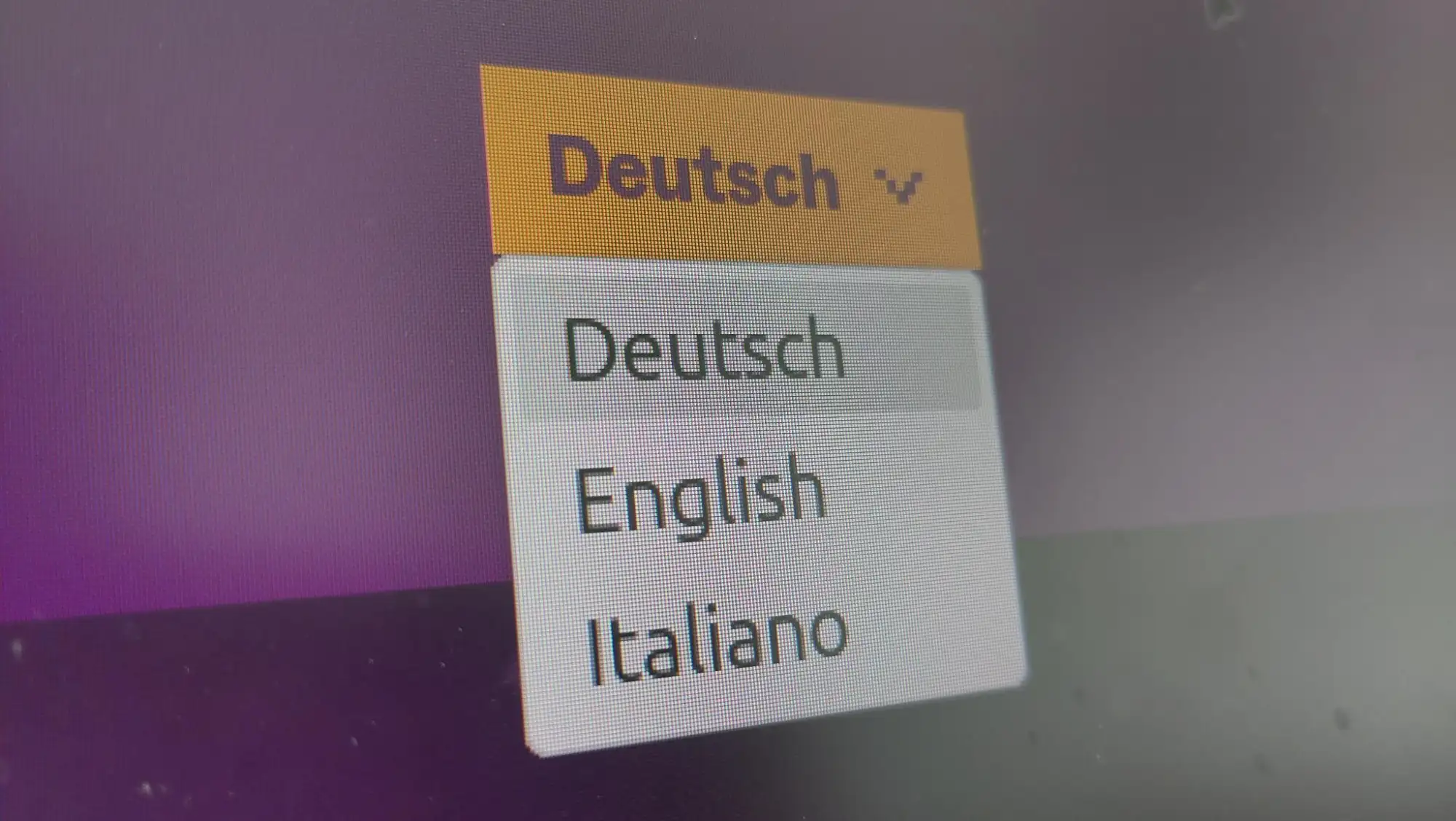 Bildschirmausschnitt mit einem Dropdown-Men&uuml;, in dem die Option 'Deutsch' aktiviert ist. Darunter sind die Sprachoptionen 'Deutsch', 'English' und 'Italiano' sichtbar.